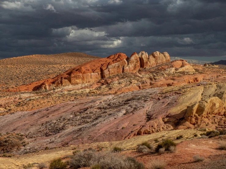 large mountains sit high in the distance under a cloudy sky