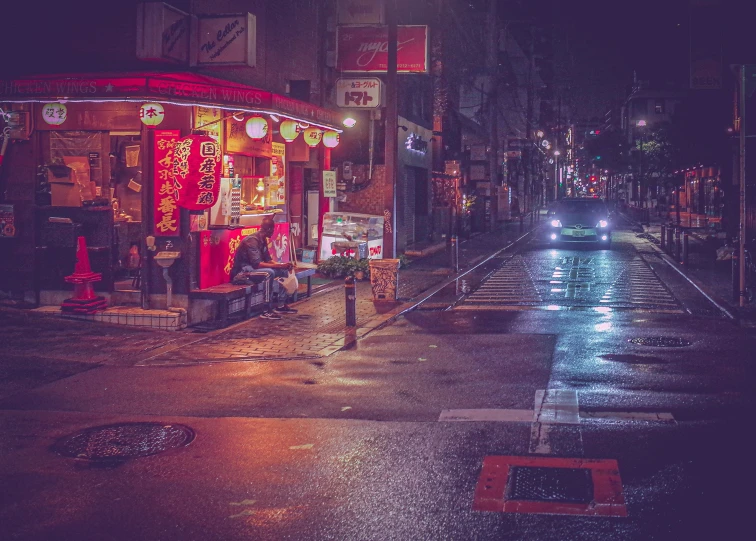 a city street with traffic lights on in the dark