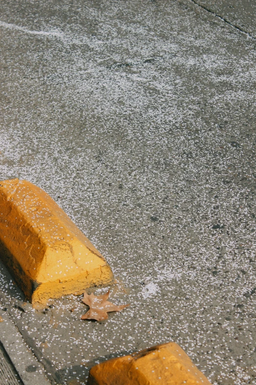 a yellow curb with a broken curb top on it