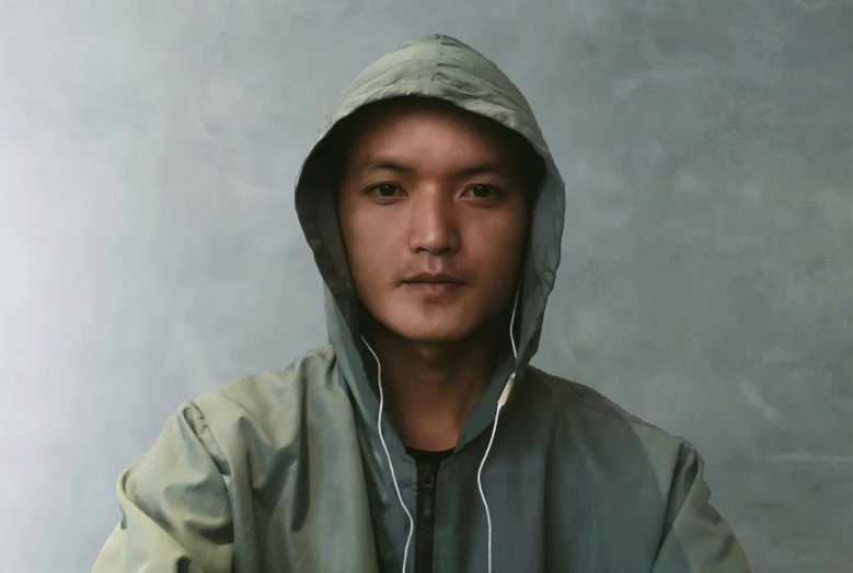 man in hoodie looking at camera and smiling