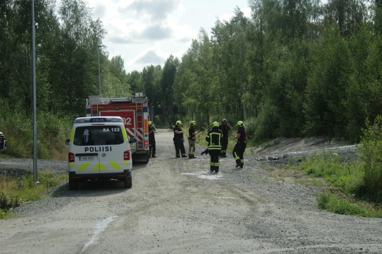 the police officers are walking towards the fire truck