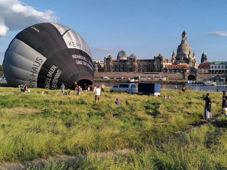 a group of people standing around a balloon