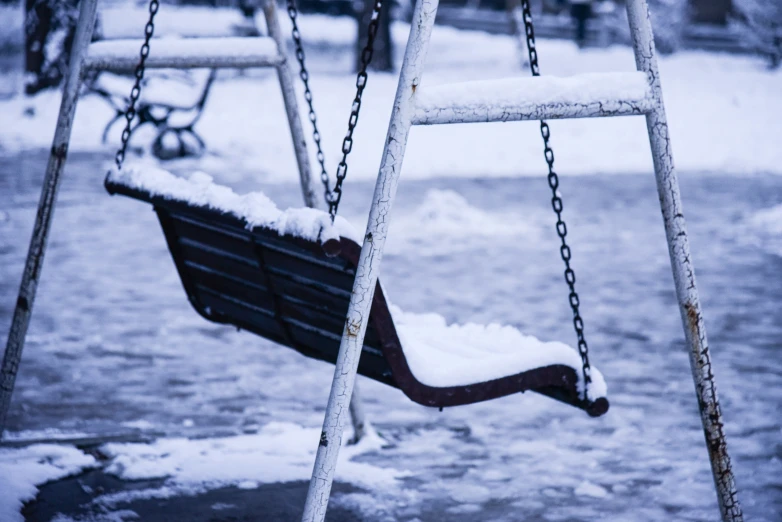 a swing that has snow on top of it