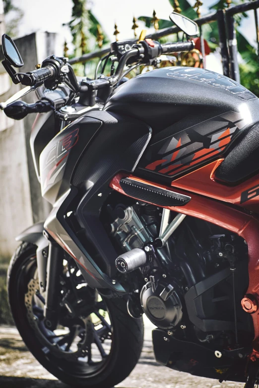 a red and black motorcycle parked on a street