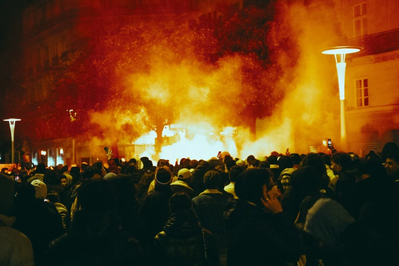 a crowd of people watching a huge fire