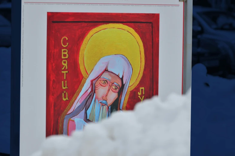 a religious painting that is above a pile of snow