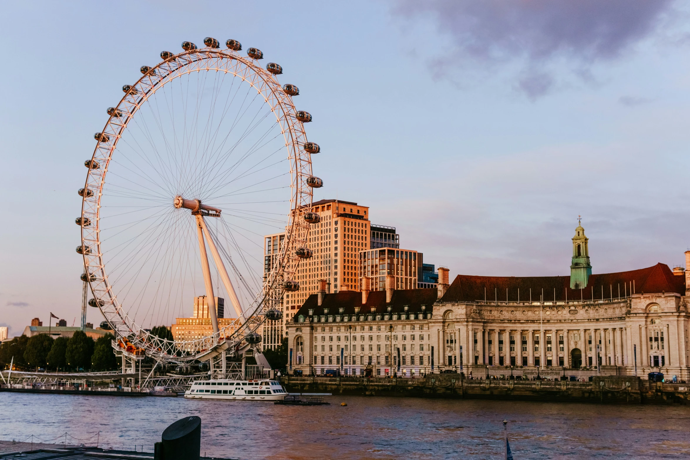 a large wheel is shown over the water