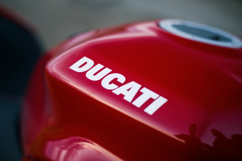 the logo is displayed on the side of a red motorcycle
