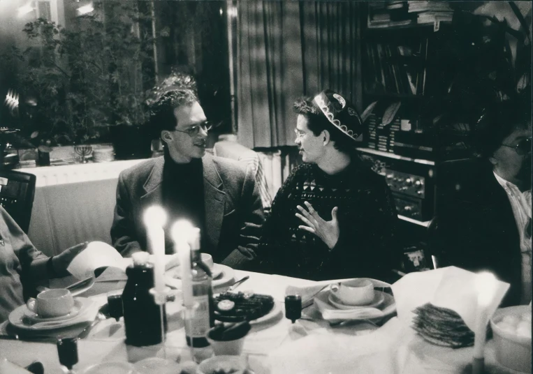 a group of people sitting at a table in a dining room