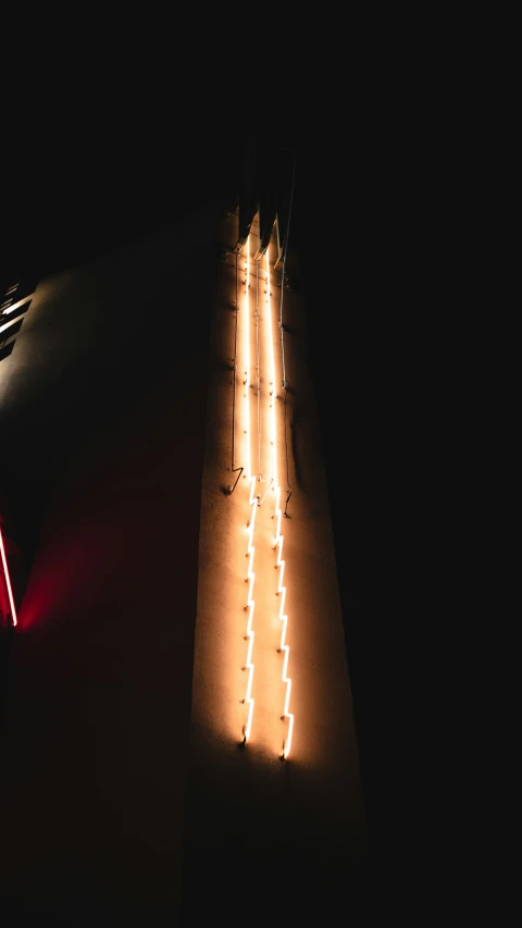 light coming from top of a building in the dark