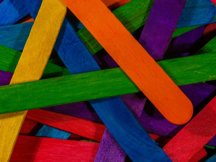 some wooden sticks sitting together in color