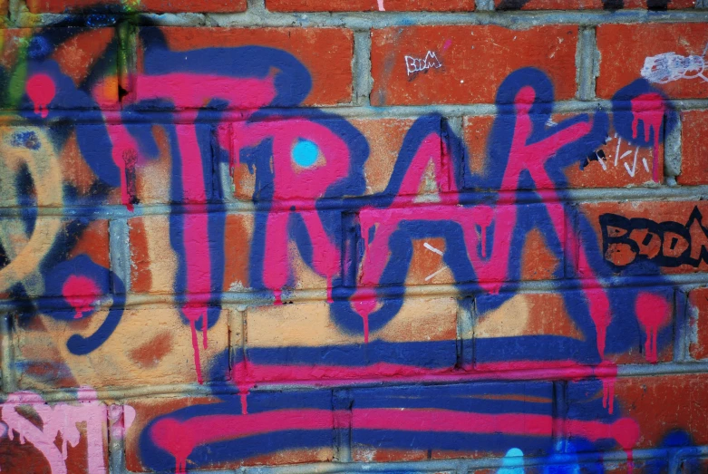 this brick wall has graffiti on it