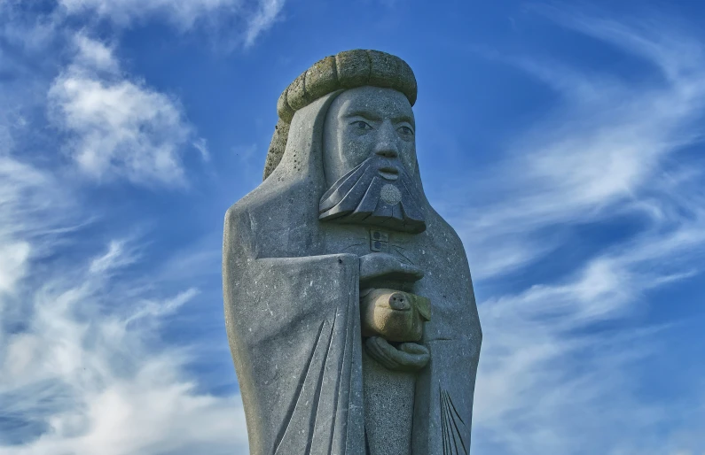 a statue of an ancient man with a cat in his arms