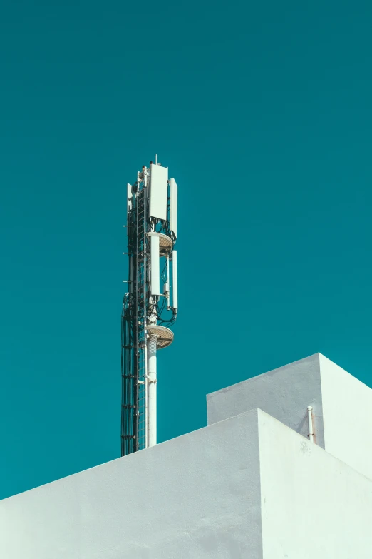 a phone tower is against a bright blue sky