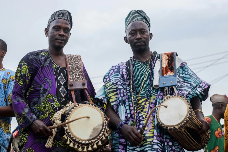 a group of people wearing colorful clothing holding instruments