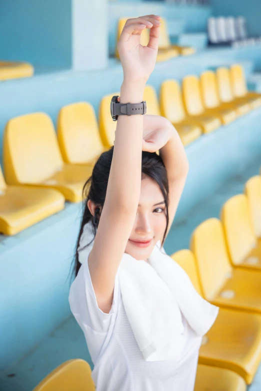 a beautiful young lady holding onto an electronic watch