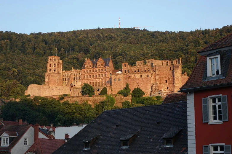 an old building that has a castle near some houses