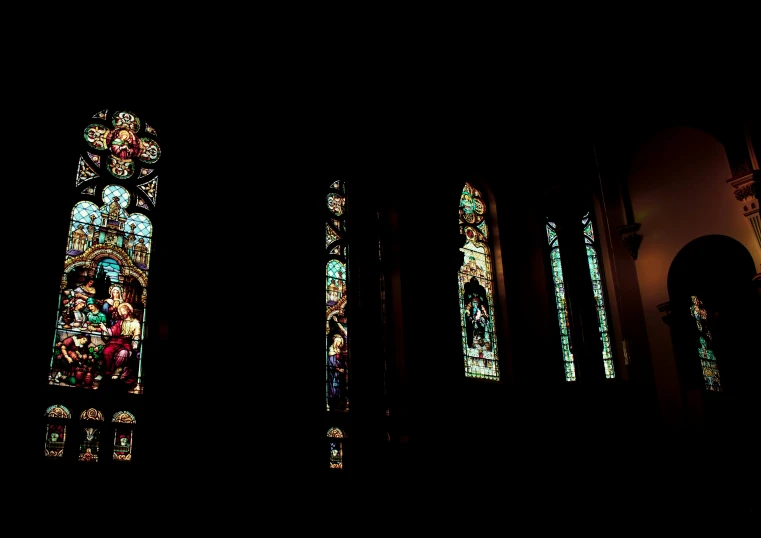 light coming through stained glass windows into a church