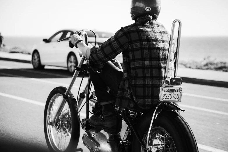 a man is riding his motorcycle on the side of the road