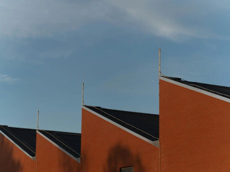 a close - up view of two brick church spires and a clock