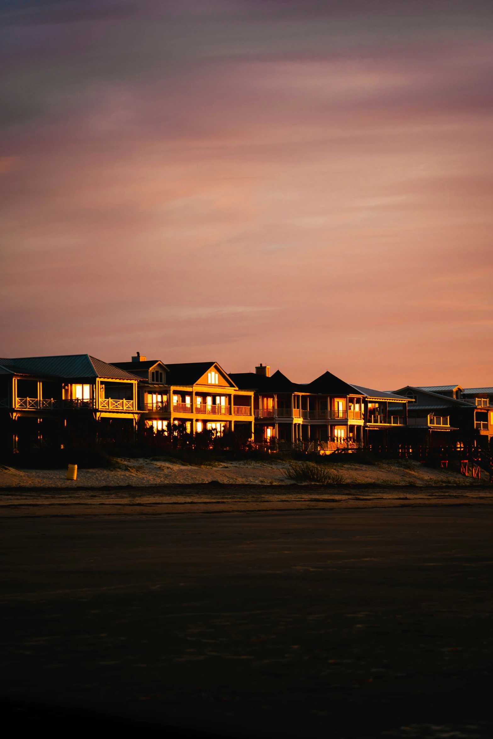 a row of large homes lit up at night