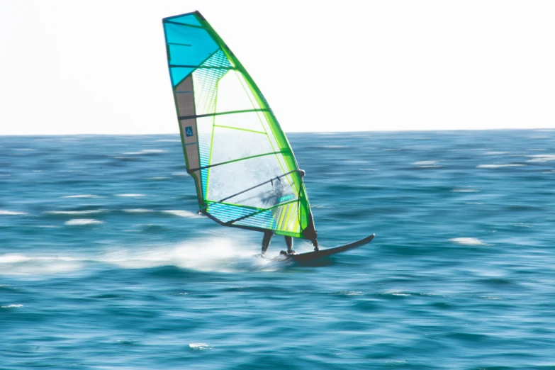 a person on the water while wind sailing