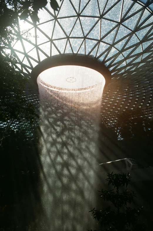 a building with some lights on it, with trees in front