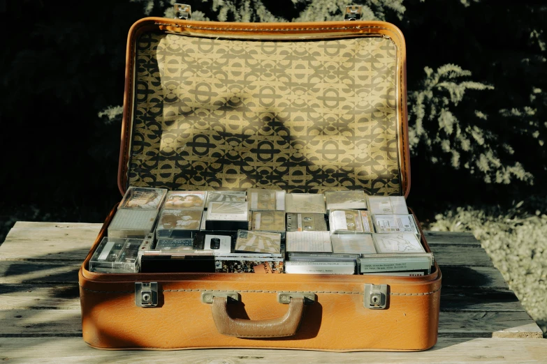an open suitcase on a wooden table outside