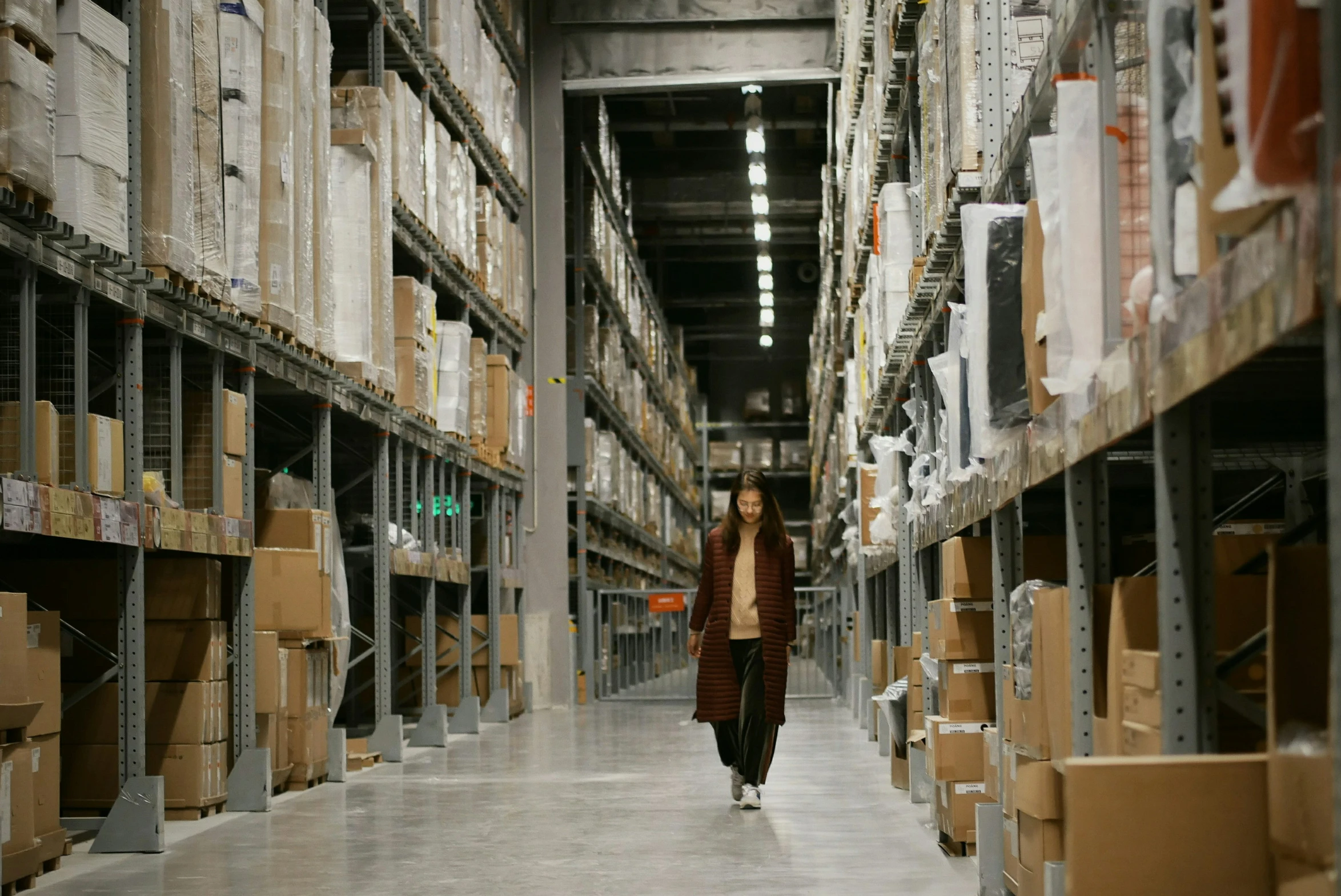 a warehouse filled with lots of shelves with boxes on each side