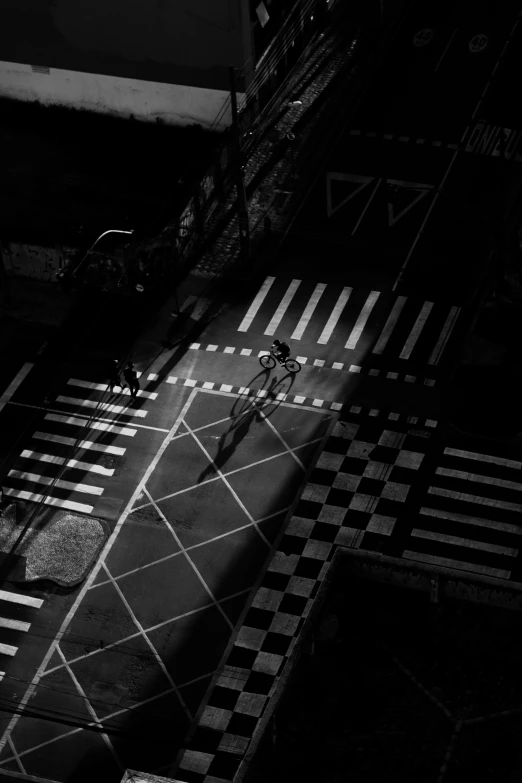 a person on a bike riding across a cross walk