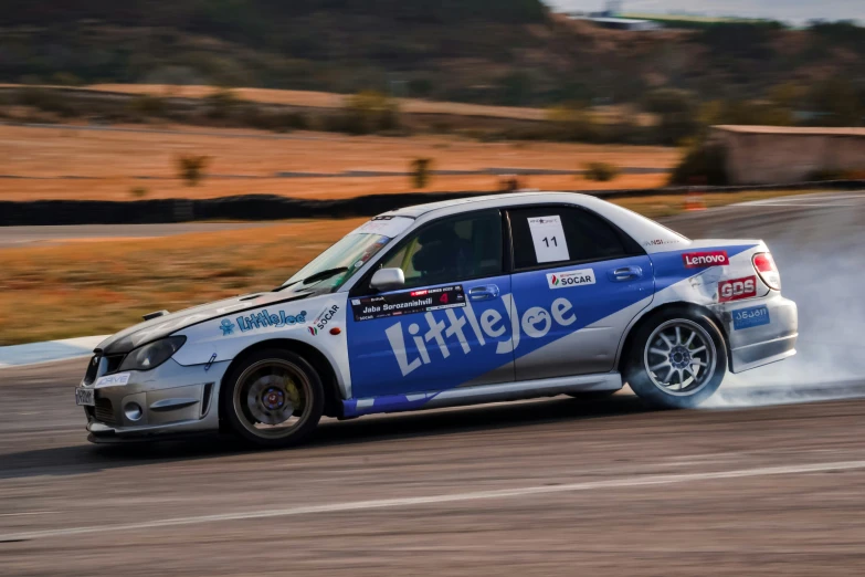 an image of a rally car hitting the road