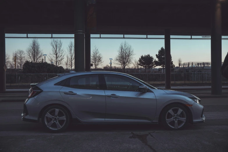 a car sits parked next to an empty parking lot