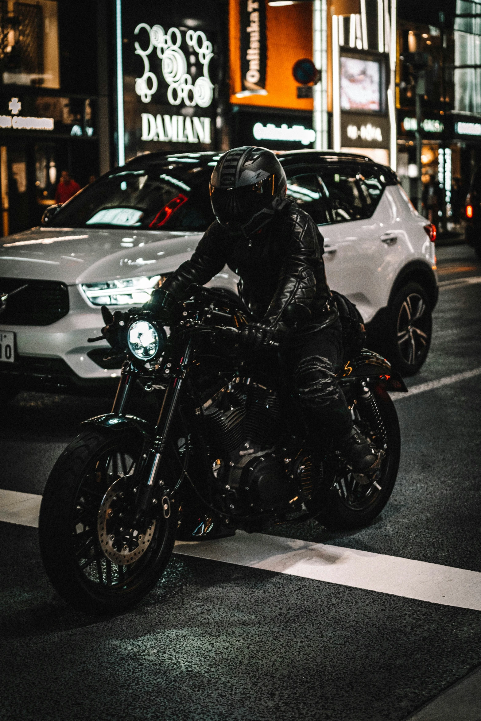 a man on a black motorcycle in the street