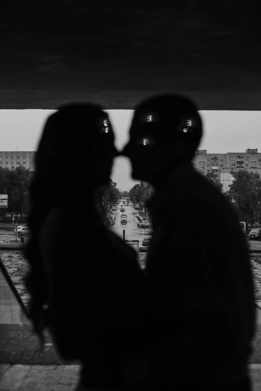 two people are kissing while standing near the road