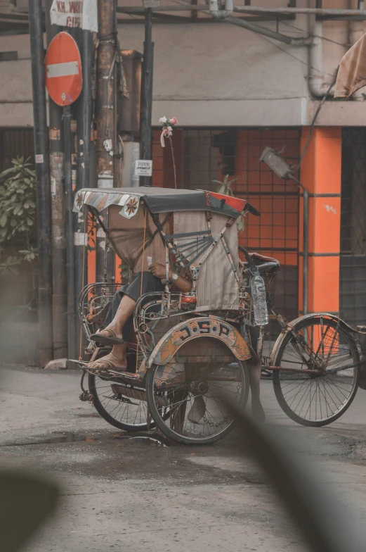 man on bike sitting with a broken wheel