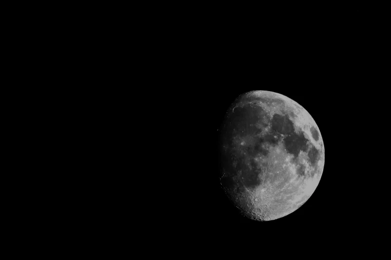 a moon shining in the sky with black background