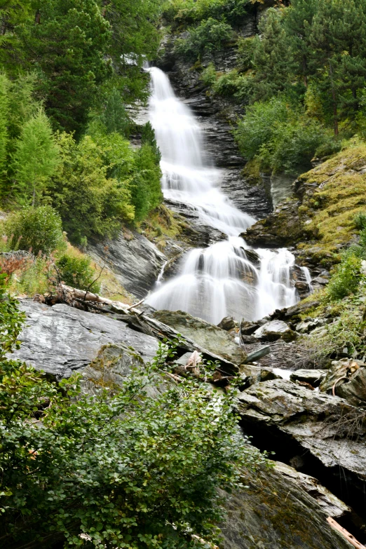 a small waterfall near the side of a hill