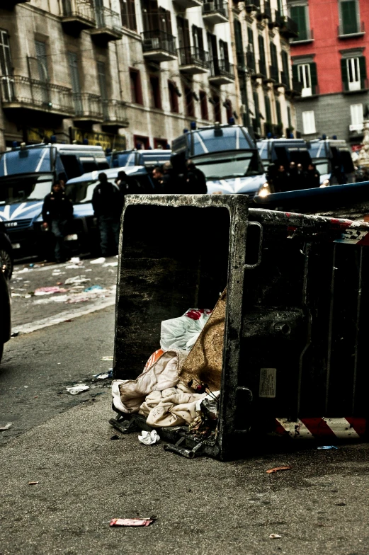 trash cans, boxes and police car on a city street