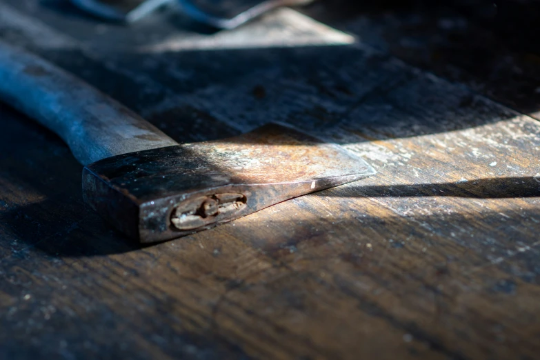 a pair of nails are sitting on a wooden table