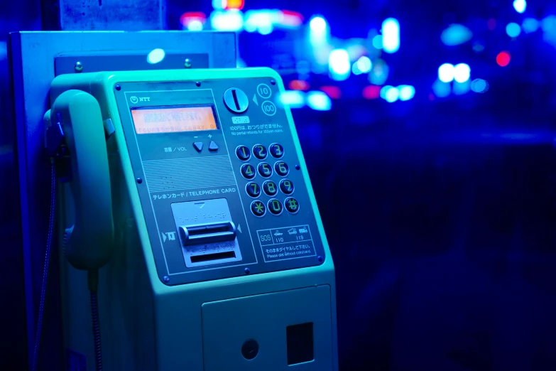 a pay phone sitting in the middle of a street