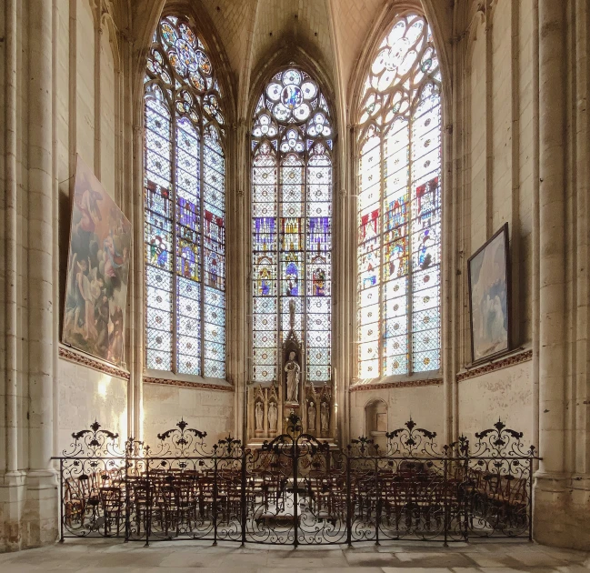 the inside of a church showing an ornate window