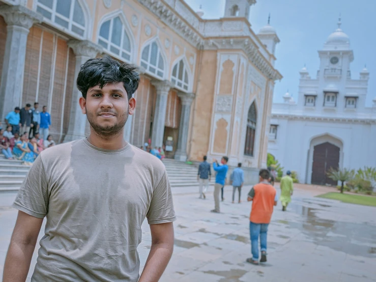 this is a young man standing in front of a building