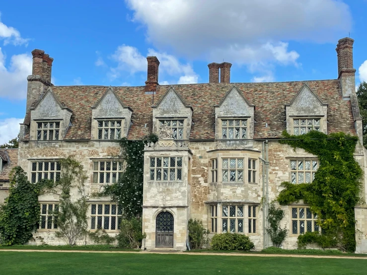 a large, stone building with ivy covering the front