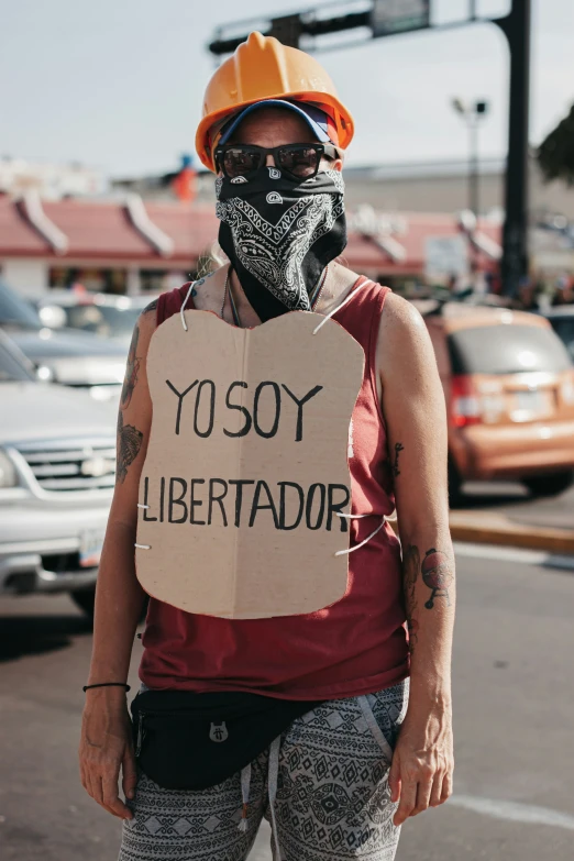 a person in the middle of a protest holding a sign