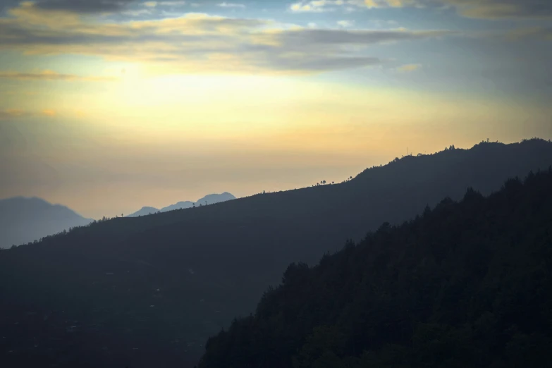 view of a mountain with trees on top of it