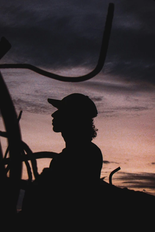 a man is standing in the silhouette against an intense sky