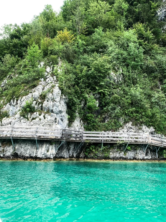 an island with a rock and wood structure in it