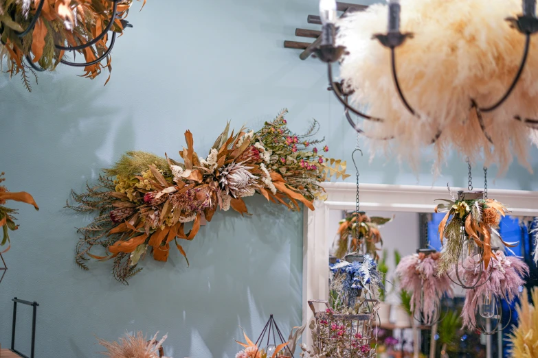 hanging objects made out of plants and feathers