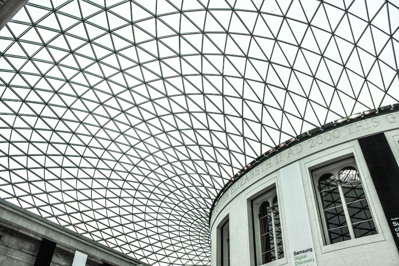 a glass atrium roof with a black and white po