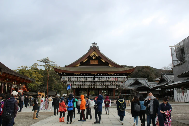 the people are walking towards an asian temple